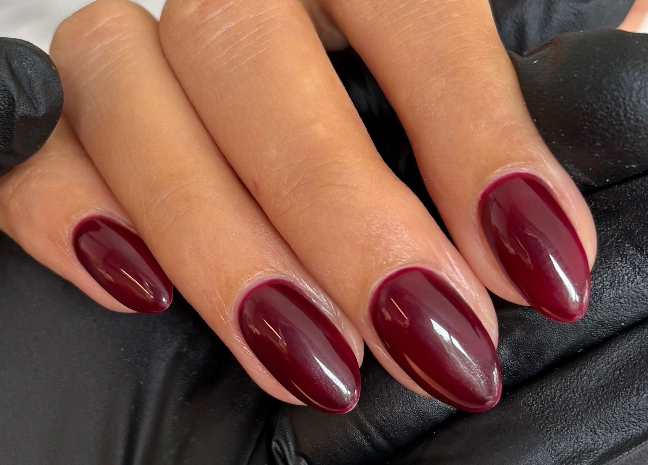 Burgundy manicured nails at The Brow & Nail Lounge, Worthing, England, GB.