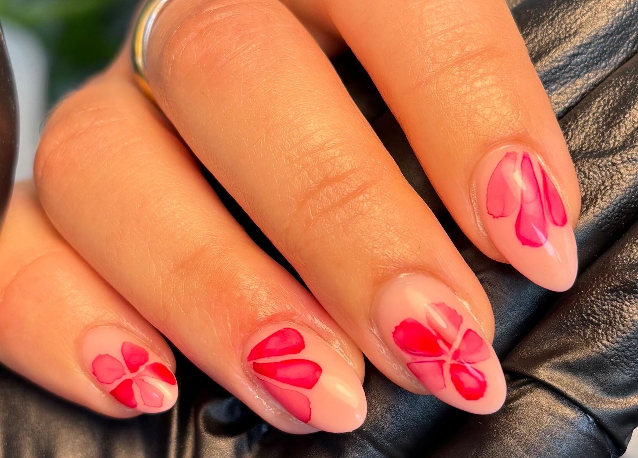 Floral nail art at The Brow & Nail Lounge, Worthing, England, GB. Beautifully designed pink and red petals.