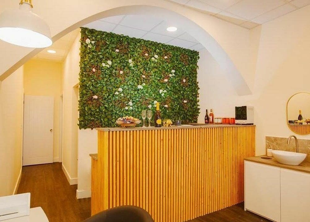 Inviting reception at D'lux Nails and Beauty Salon, London, England, GB, featuring a lush green wall decor.