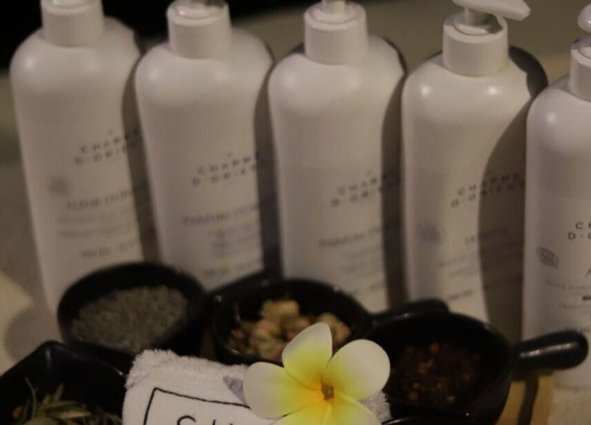 Luxurious spa products at She Spa Al Ain, العين, أبو ظبي, AE, featuring Charme D'Orient bottles and a flower.