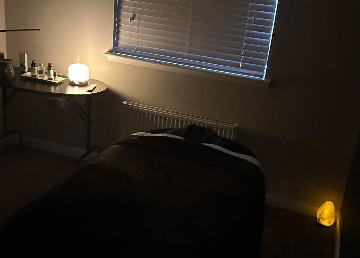 Relaxing room at Beauty By Dennon, West Calder, Scotland, GB, featuring a massage table and ambient lighting.