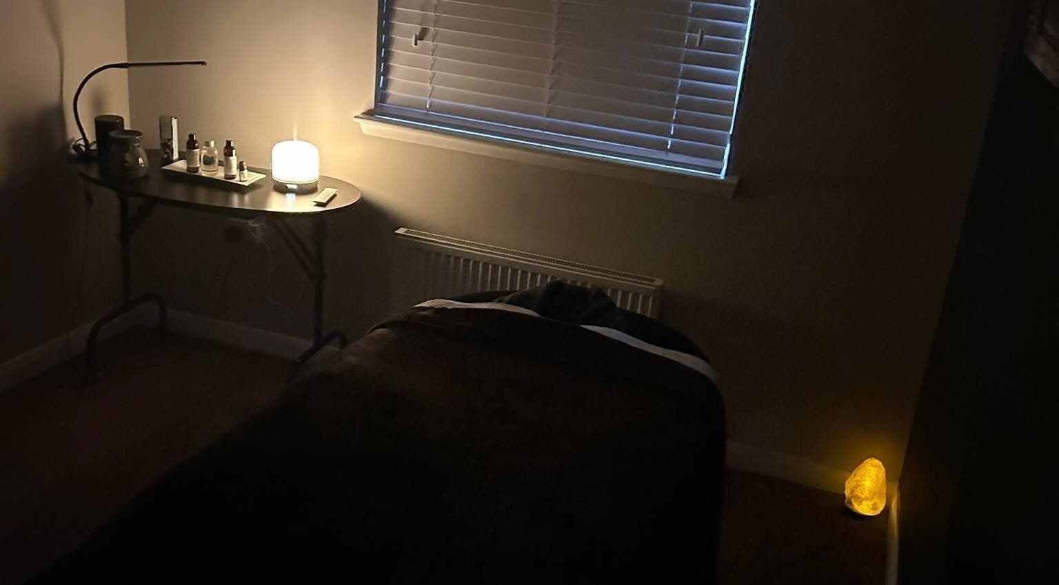 Relaxing room at Beauty By Dennon, West Calder, Scotland, GB, featuring a massage table and ambient lighting.