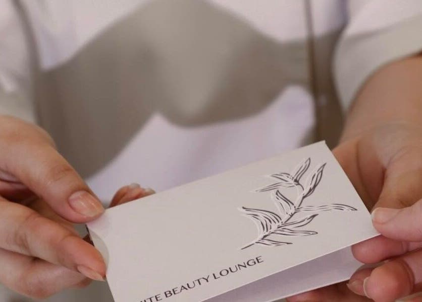 A client receives a card at Izghawa Branch, الريان, الريان, QA, symbolizing beauty and relaxation.