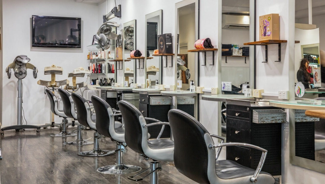Modern salon interior at Maddness Hair Design in Bundoora, Victoria, AU features stylish seating and mirrors.