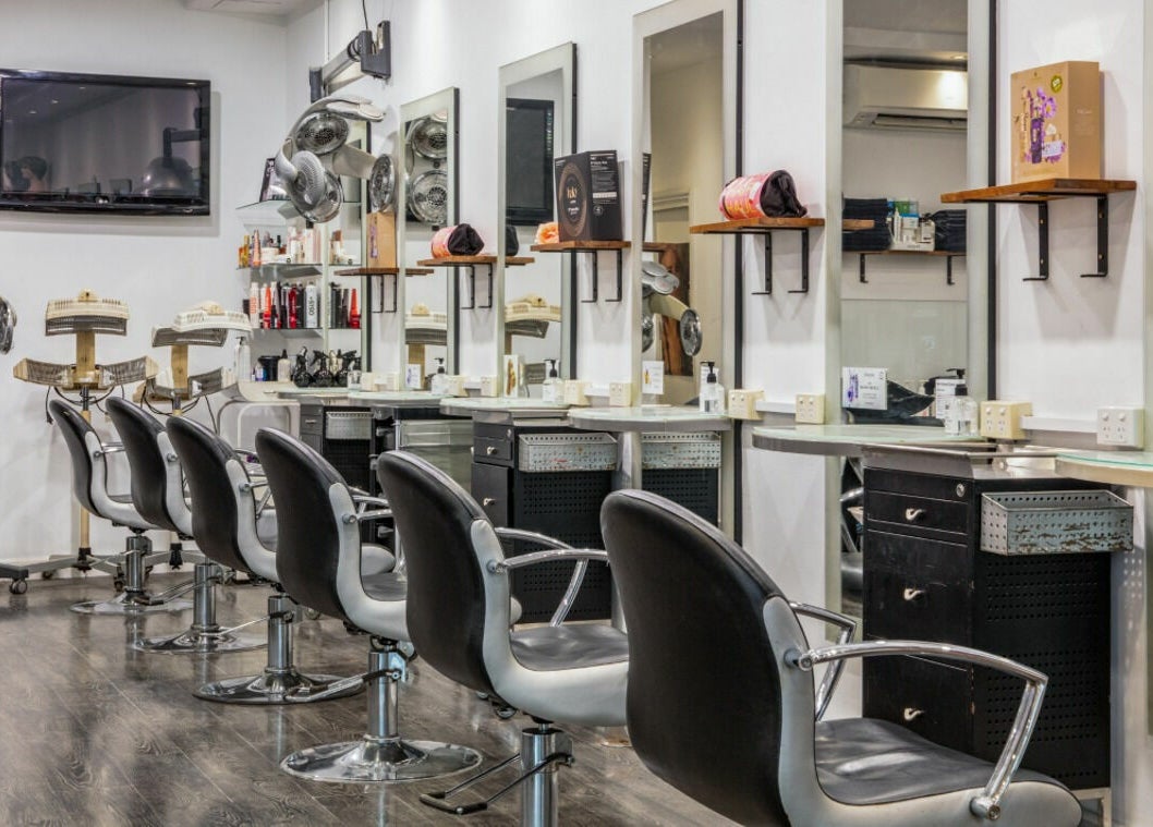 Modern salon interior at Maddness Hair Design in Bundoora, Victoria, AU features stylish seating and mirrors.