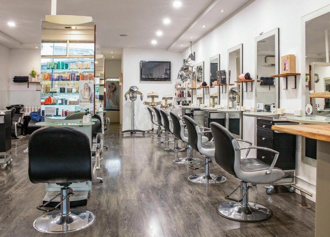 Stylish interior of Maddness Hair Design in Bundoora, Victoria, AU with modern salon chairs and mirrors.