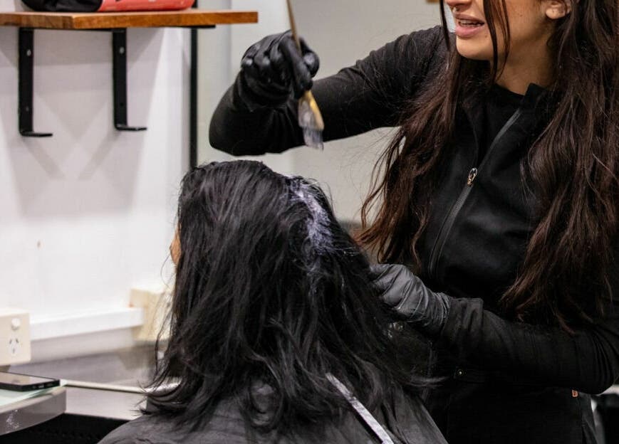 A stylist applies hair color at Maddness Hair Design in Bundoora, Victoria, AU.