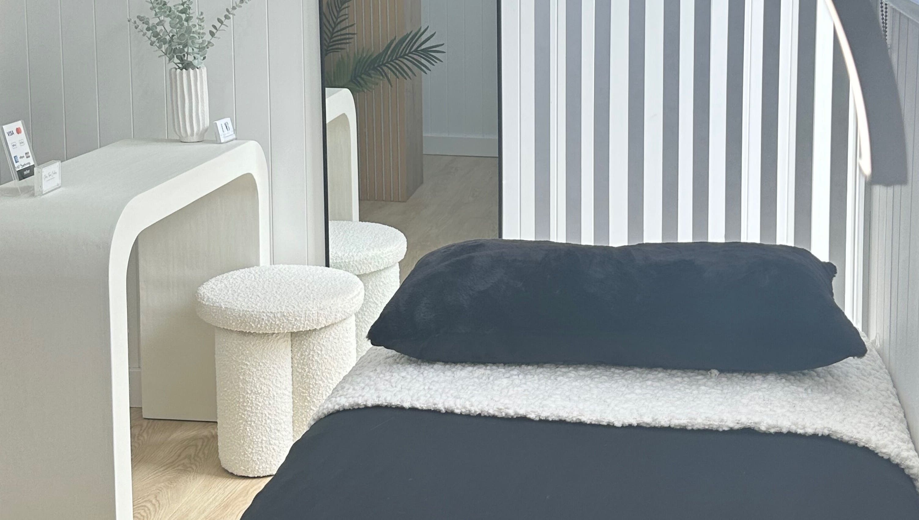 Relaxing therapy room at Lab Lounge, Blacksmiths, New South Wales, AU, featuring a plush bed and modern decor.