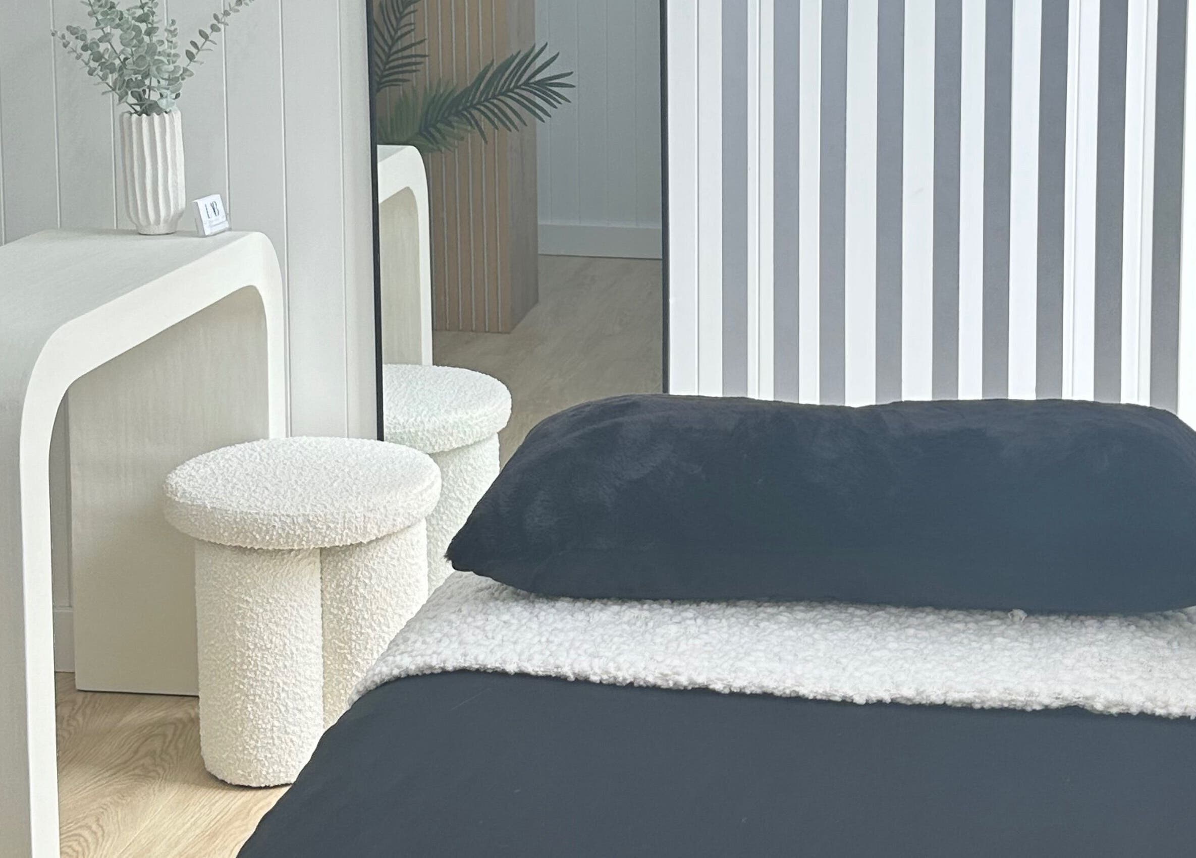 Relaxing therapy room at Lab Lounge, Blacksmiths, New South Wales, AU, featuring a plush bed and modern decor.