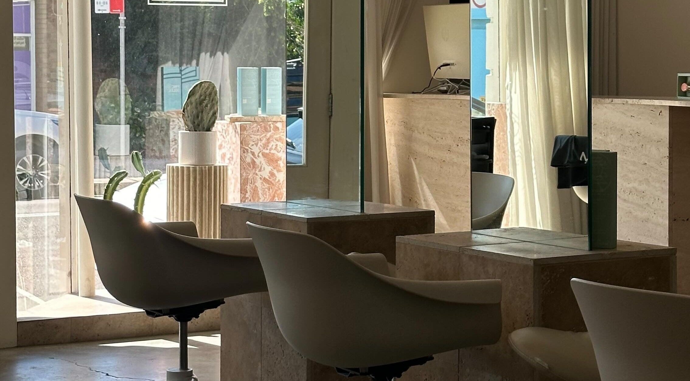 Modern salon chairs and mirrors at Lab Lounge, Blacksmiths, New South Wales, AU. Sunlit and inviting interior.