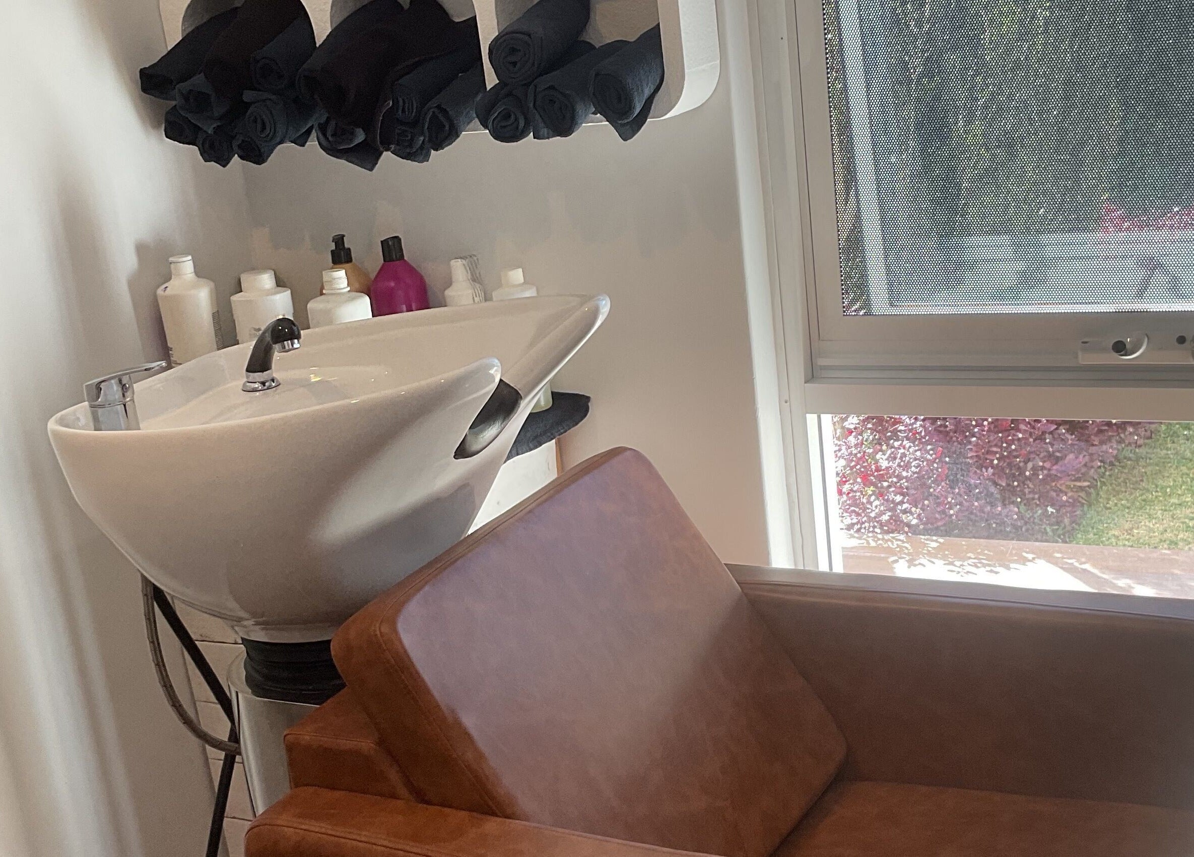 Chic salon wash station with brown chair at Blossom Hair Artistry, Quinns Rocks, Western Australia, AU.