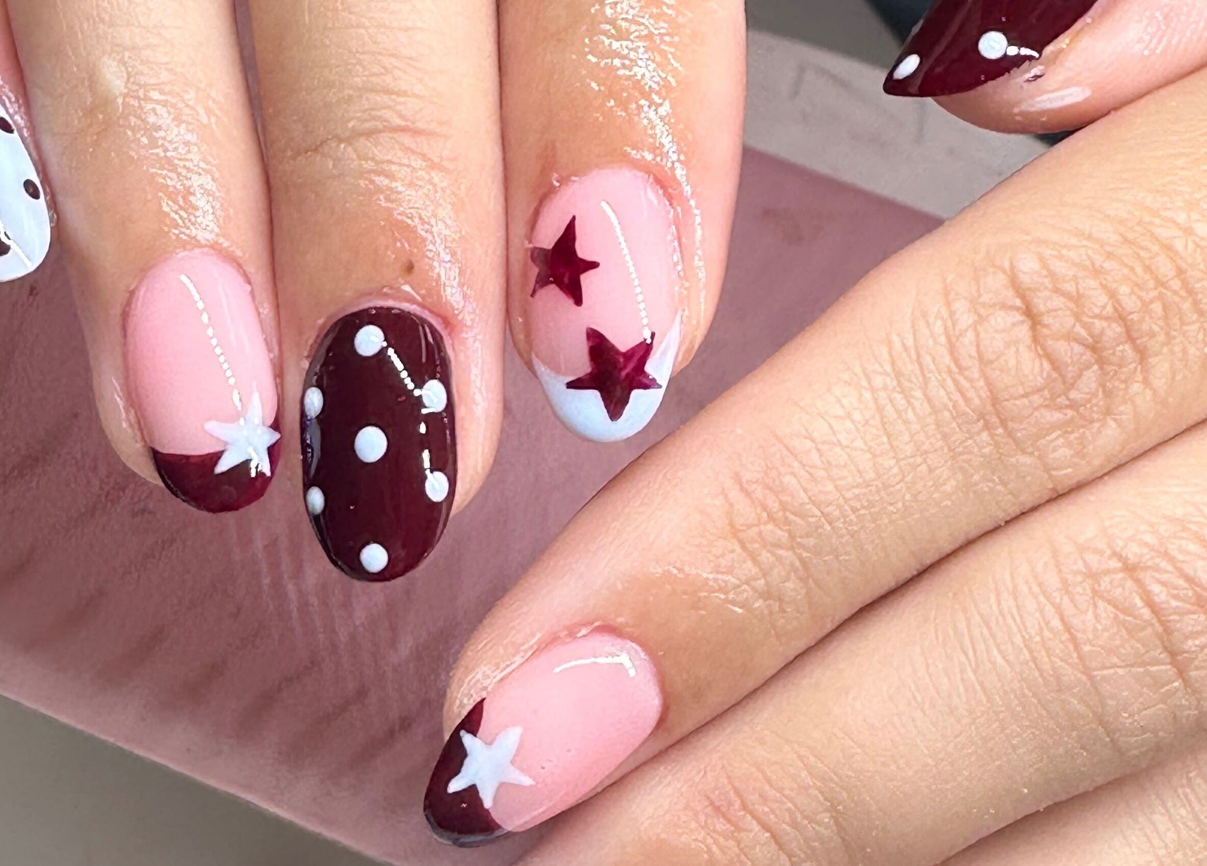 Stylish nail art with star and polka dot design by Beauty by Emily, Stevenage, England, GB.