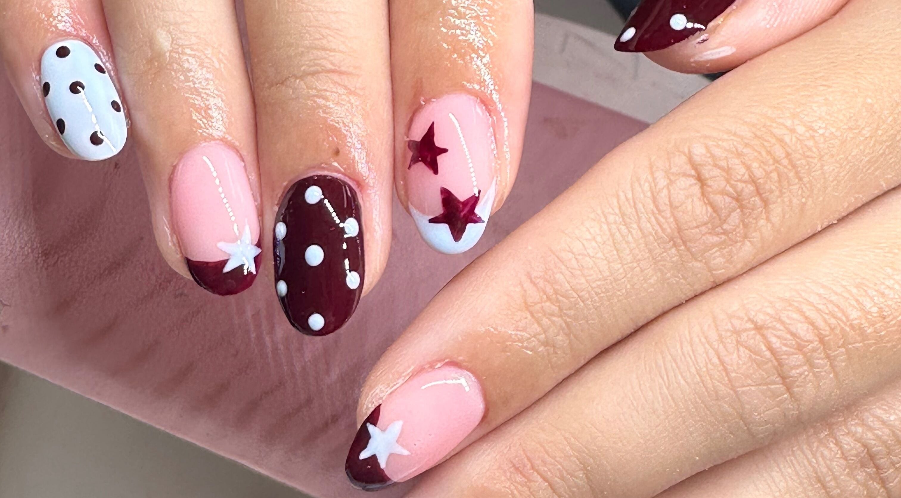 Stylish nail art with star and polka dot design by Beauty by Emily, Stevenage, England, GB.