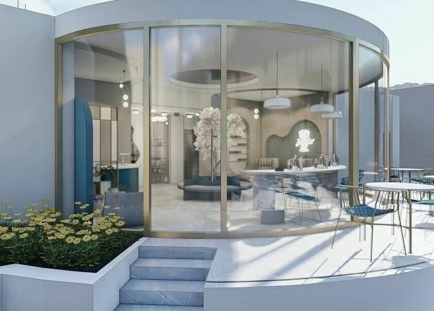 Modern exterior of Leen Beauty Center in Aqaba, JO with glass walls and outdoor seating.