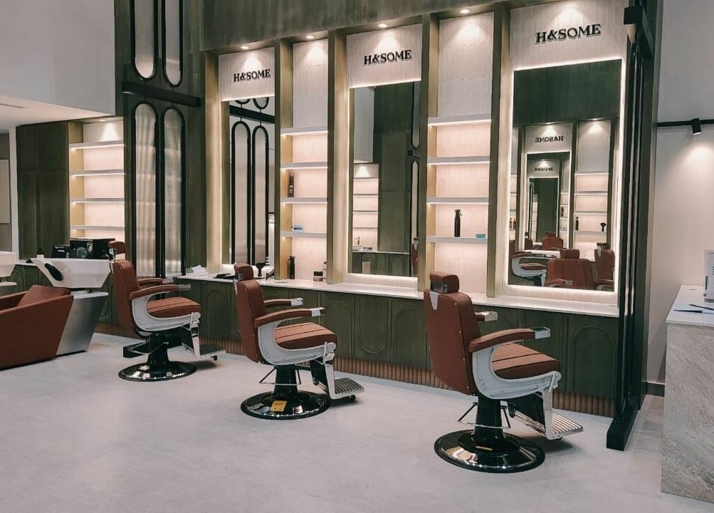 Chic interior of Handsome - هاندسم in Riyadh, Riyadh Province, SA, featuring stylish barber chairs and mirrors.