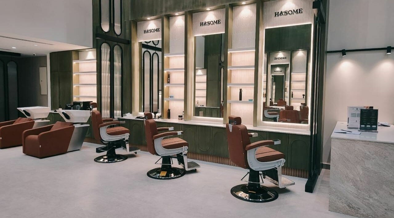 Chic interior of Handsome - هاندسم in Riyadh, Riyadh Province, SA, featuring stylish barber chairs and mirrors.