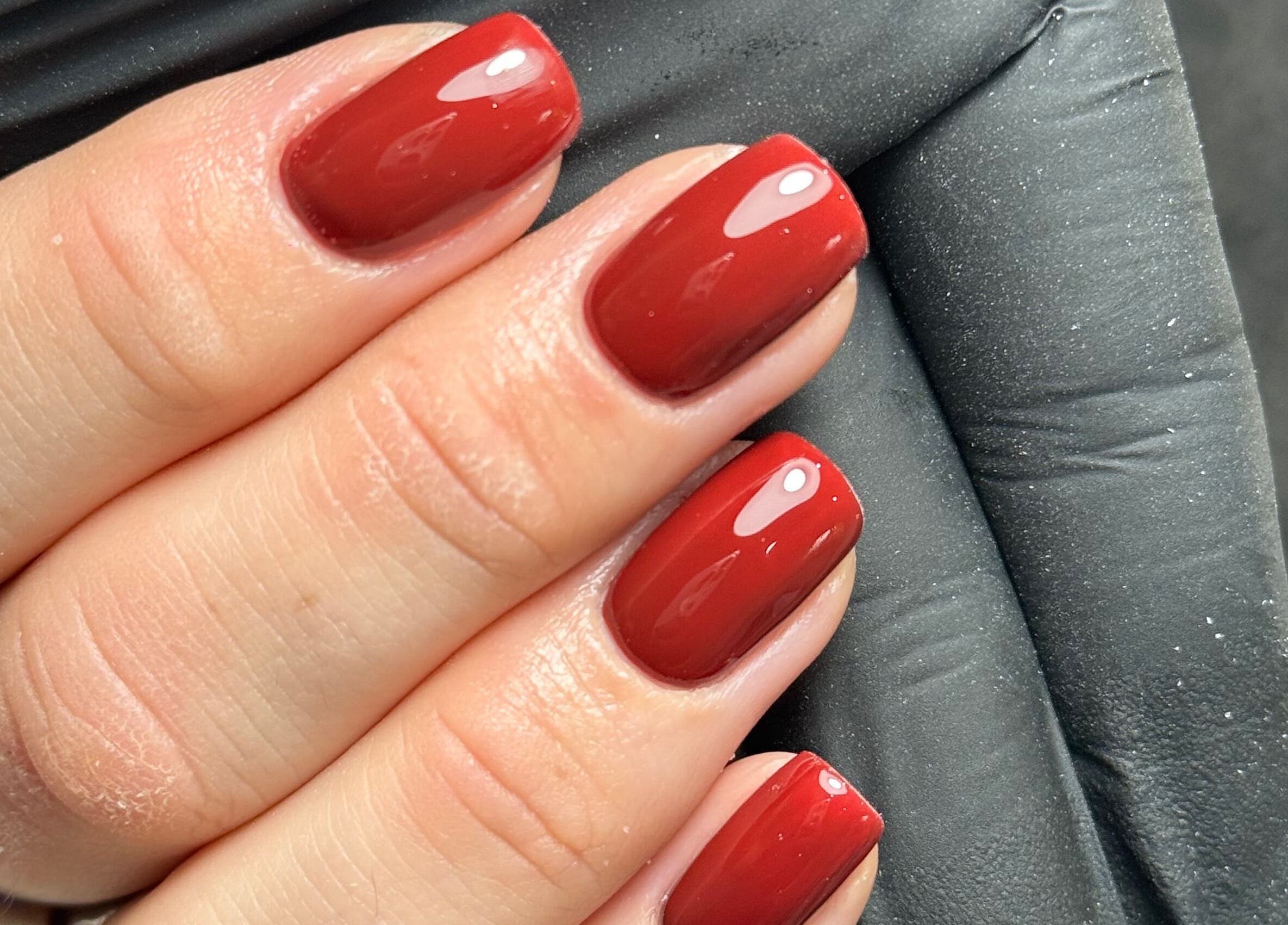Elegant red manicure at Chloe’s Beauty Spot, Torquay, England, GB. Perfect for stylish nail care.