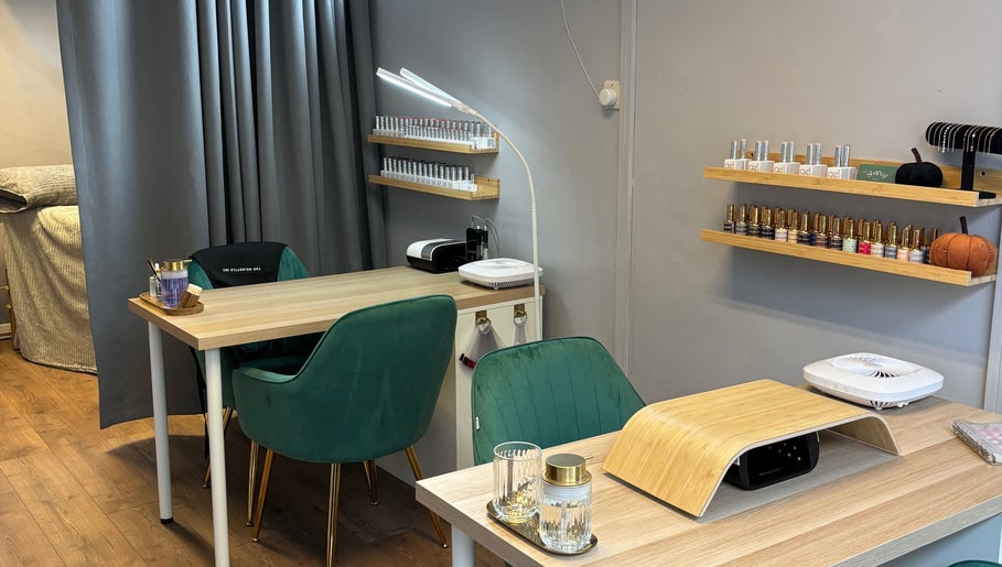 Modern nail salon interior at Beauty Mi, Sunbury-on-thames, England, GB, with stylish green chairs and nail polish racks.