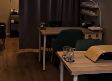 Cozy Beauty Mi treatment room with wooden tables in Sunbury-on-Thames, England, GB.