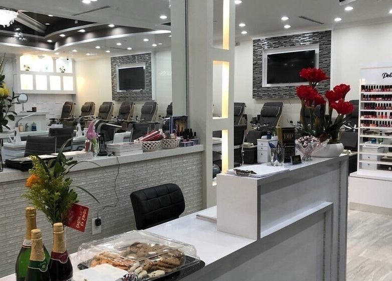 Elegant interior of D'Luxe Nail-Ocotillo, Chandler, Arizona, US, featuring a pristine counter and spa chairs.