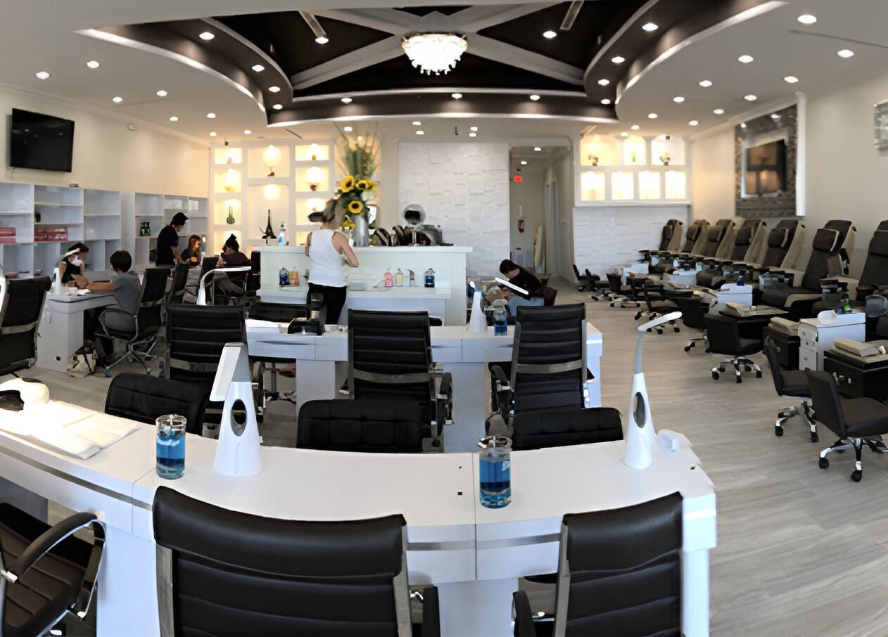 Inside view of D'Luxe Nail-Ocotillo, Chandler, Arizona, US, featuring sleek nail stations and cozy chairs.