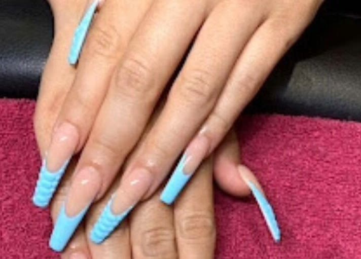 Stylish blue nails at D'Luxe Nail-Ocotillo, Chandler, Arizona, US, showcasing intricate nail art.