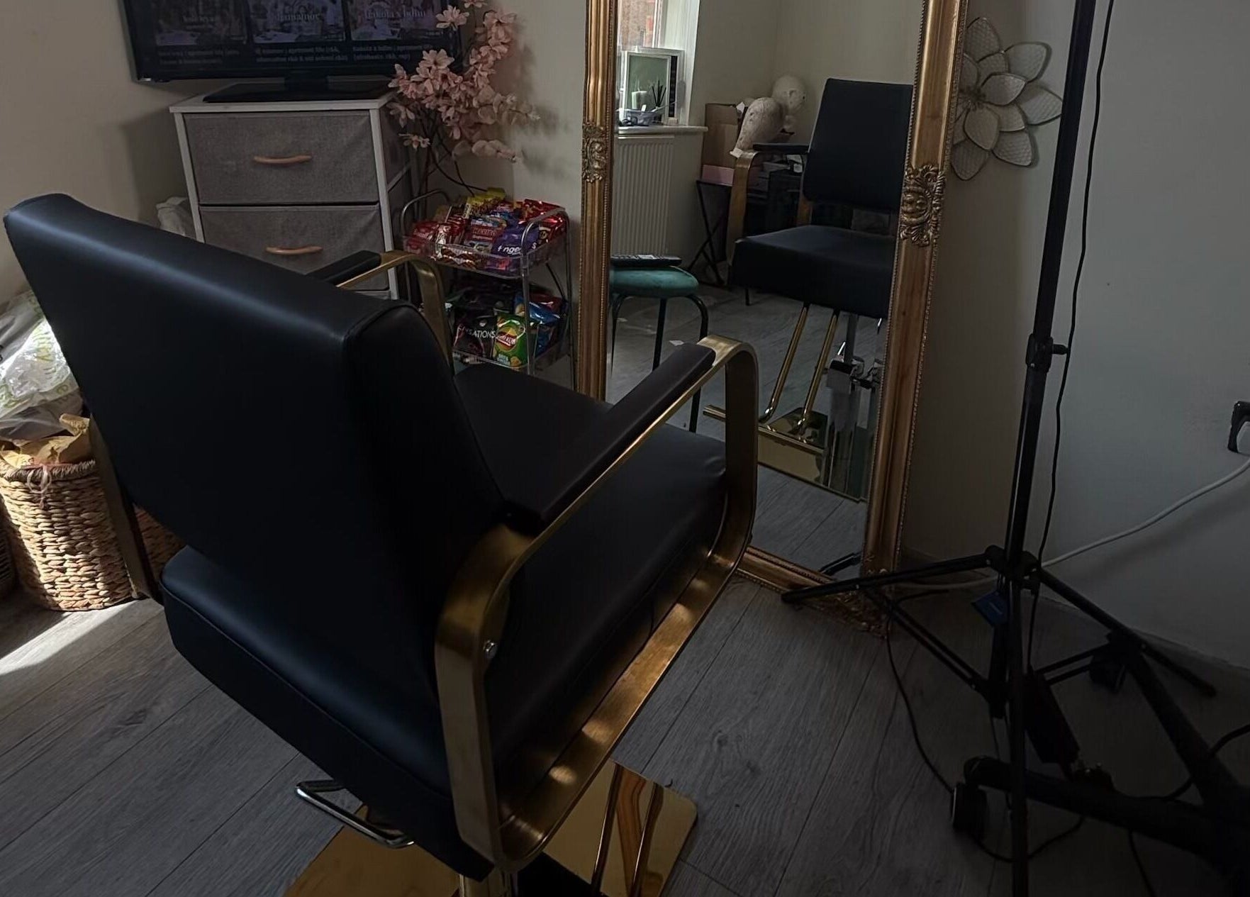 Luxurious salon chair in Ace Beauty Bar, Peterborough, England, GB, reflecting in a large ornate mirror.
