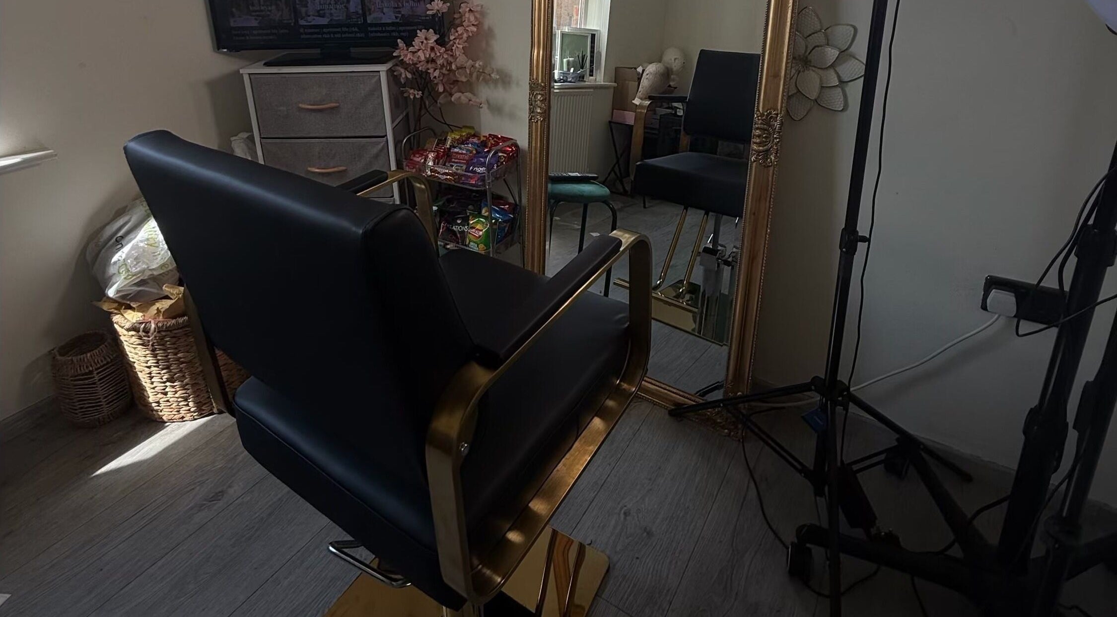 Luxurious salon chair in Ace Beauty Bar, Peterborough, England, GB, reflecting in a large ornate mirror.