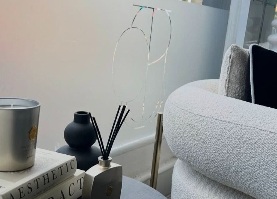 Cozy modern decor at Lush Nails by Leah, Leeds, England, GB, featuring a candle and diffuser on books.