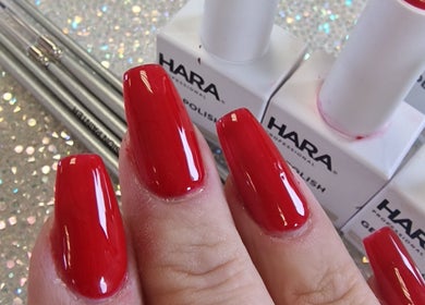 Vibrant red nail design at Cuteikell Nail Design, Plympton, England, GB, featuring glossy polish finish.