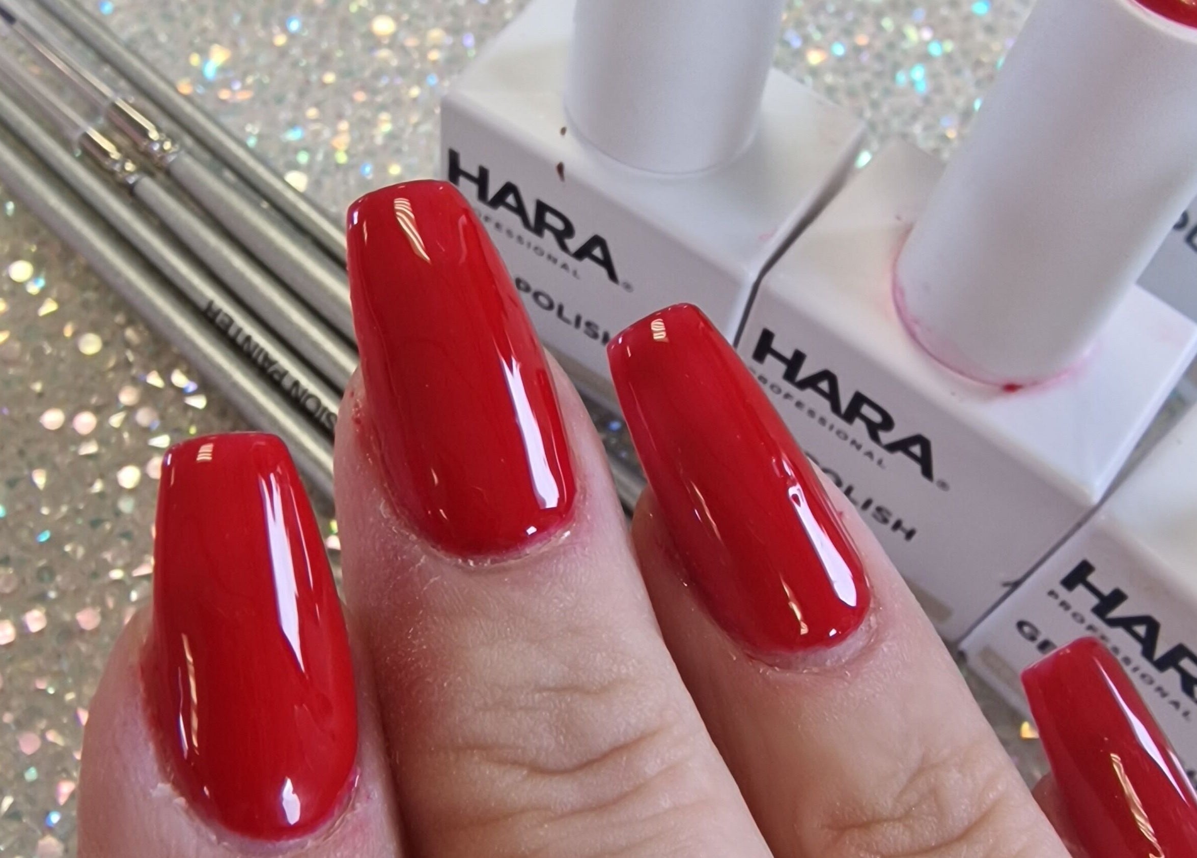 Vibrant red nail design at Cuteikell Nail Design, Plympton, England, GB, featuring glossy polish finish.