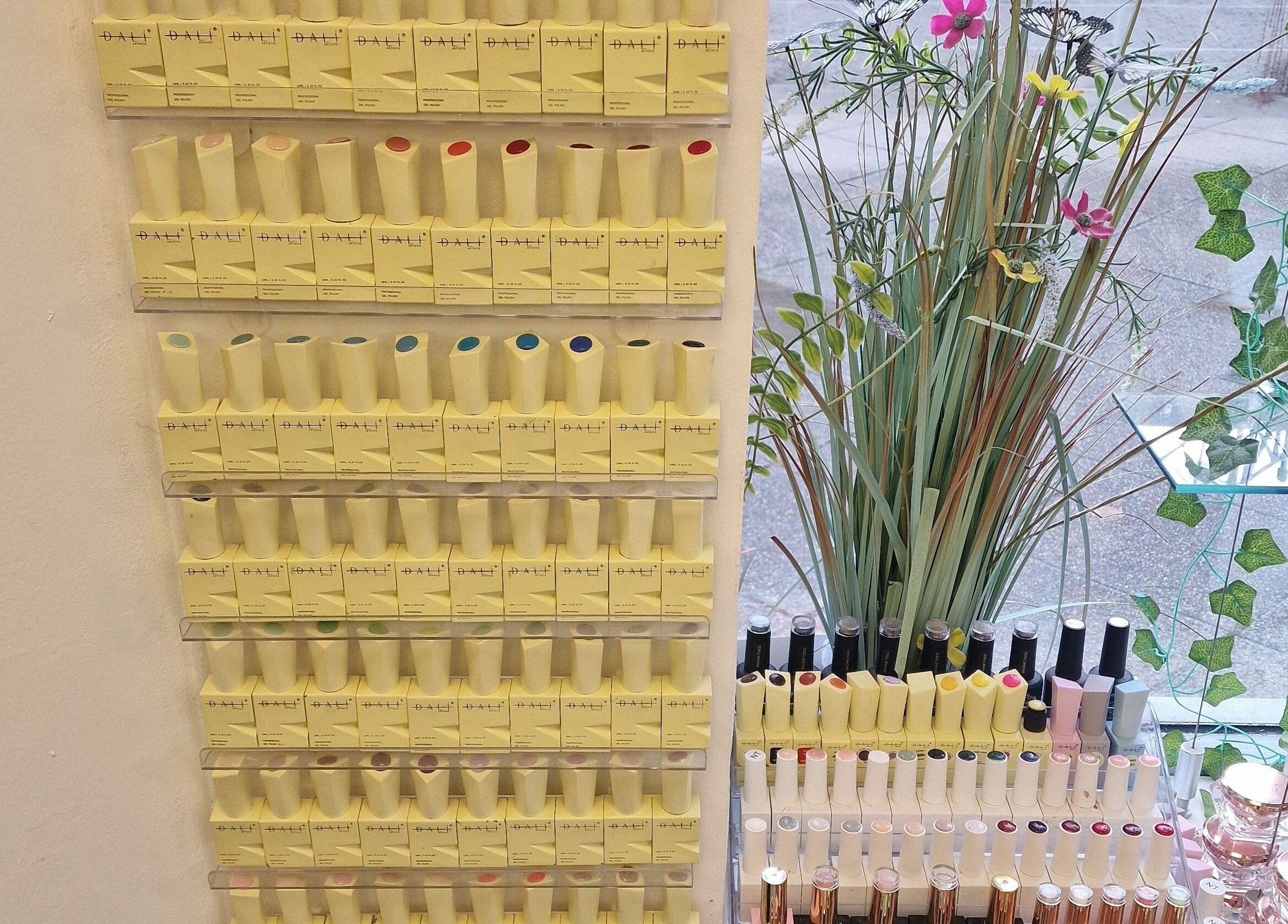 Colorful nail polish display at Cuteikell nail design in Plympton, England, GB showcasing vibrant options.