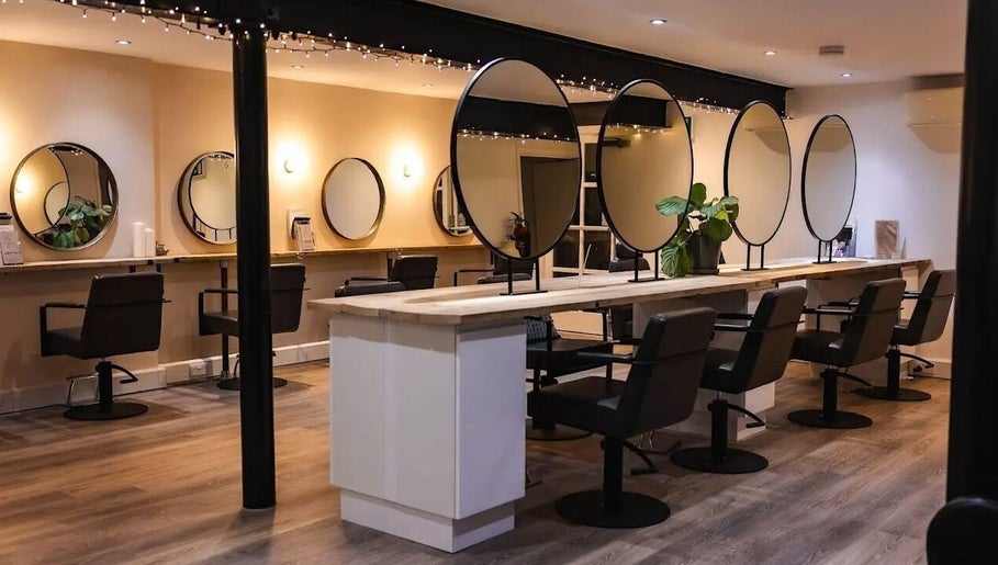 Modern salon interior at Skin Muse by Emma, Stratton Audley, England, GB, featuring sleek styling stations.