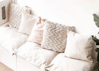 Inviting lounge area with white cushions at Skin Muse by Emma, Stratton Audley, England, GB.