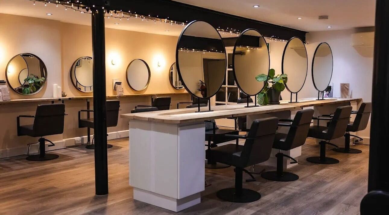 Modern salon interior at Skin Muse by Emma, Stratton Audley, England, GB, featuring stylish black chairs and mirrors.