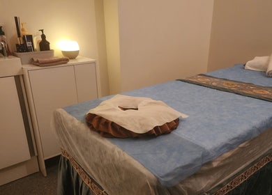 Cozy massage room at G'Day Massage Perth, featuring a neatly made bed and soft lighting in Perth, Western Australia, AU.