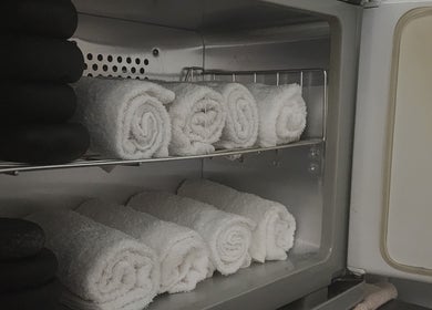Rolled towels in a warmer at G'Day Massage Perth, Perth, Western Australia, AU, offering relaxation essentials.