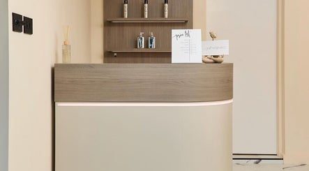 Elegant reception desk at Laser Lounge in Ramsbottom, England, GB with decor and product display.