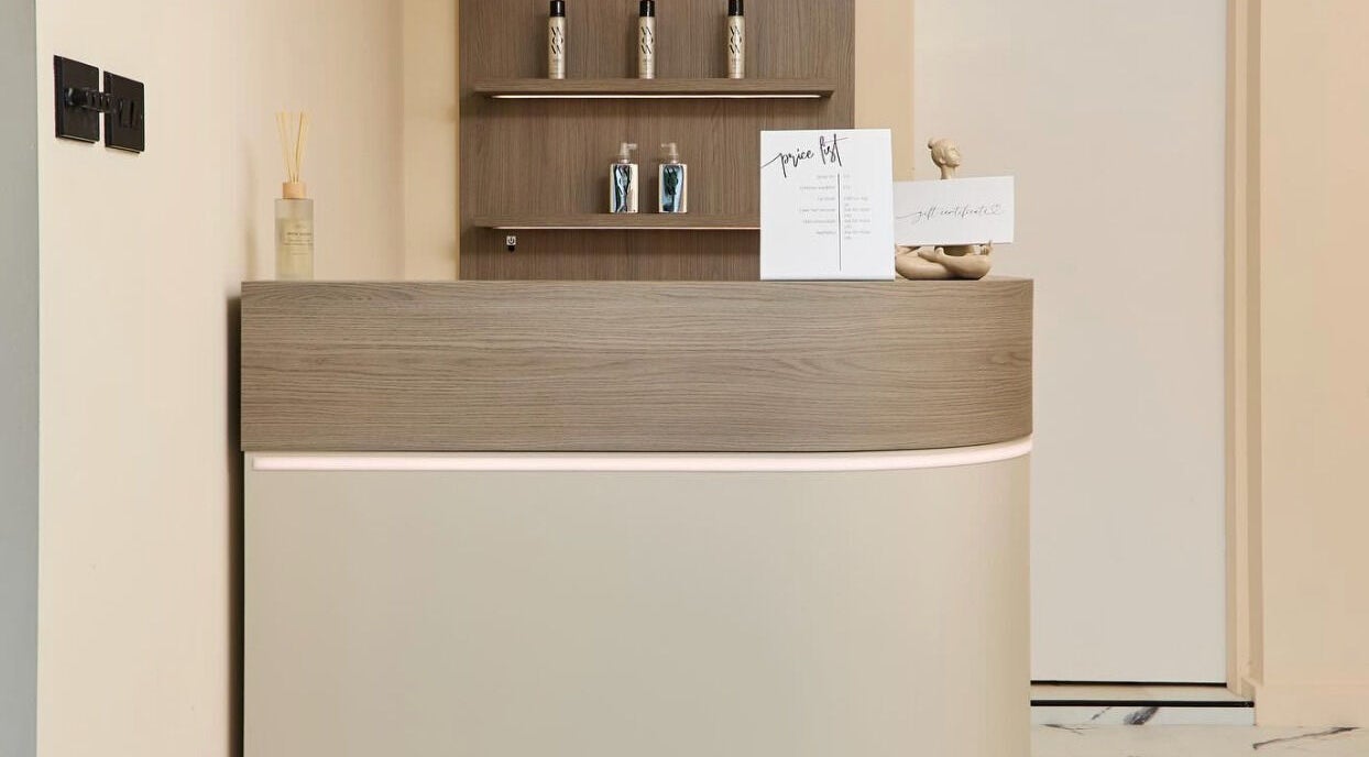 Elegant reception desk at Laser Lounge in Ramsbottom, England, GB with decor and product display.