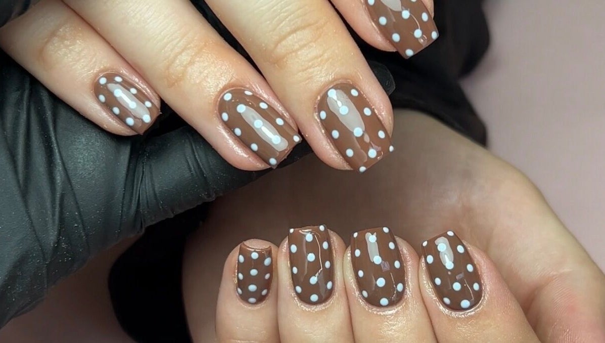 Brown nails with white polka dots by Nails by Chloe, Harrogate, England, GB.