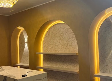Elegant interior of Kikis Beauty Bar in Willemstad, Curaçao, CW with illuminated arches and marble counter.