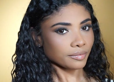 Close-up of a woman with glossy lips and curled hair at Kikis Beauty Bar, Willemstad, Curaçao, CW.