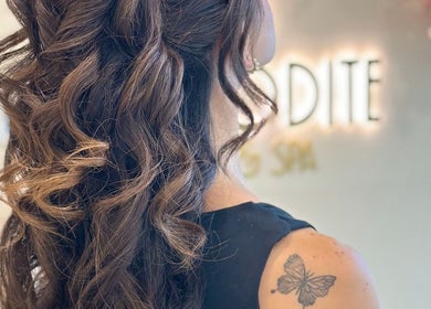 Elegant hairstyle at Aphrodite Beauty & Spa, Abu Dhabi, Abu Dhabi, AE with intricate curls and butterfly tattoo.