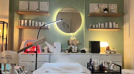 Bright treatment room at Misskin & Laser Studio, Birmingham, England, GB with skincare products and ambient lighting.