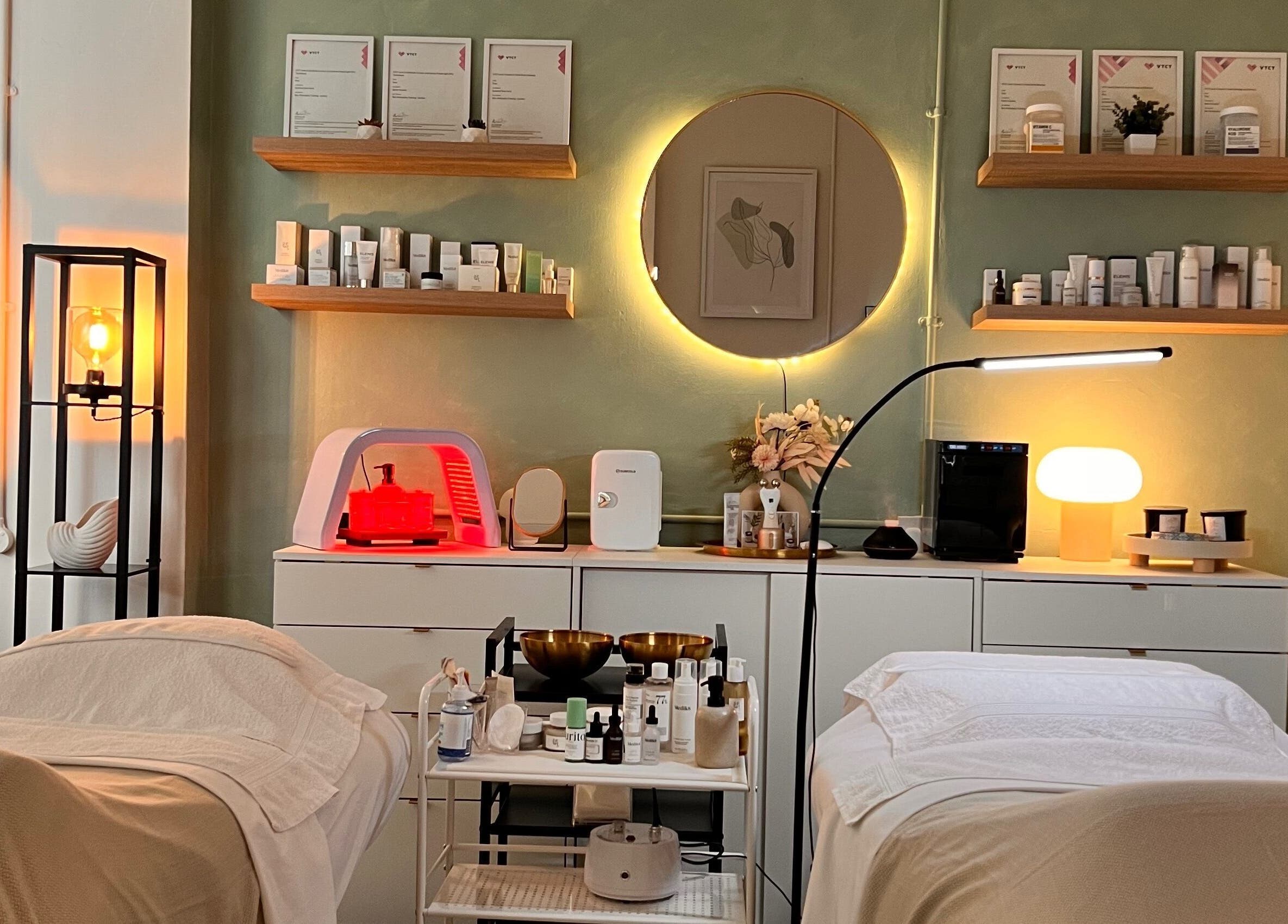Elegant treatment room at Misskin & Laser Studio, Birmingham, England, GB, featuring warm lighting and skincare products.