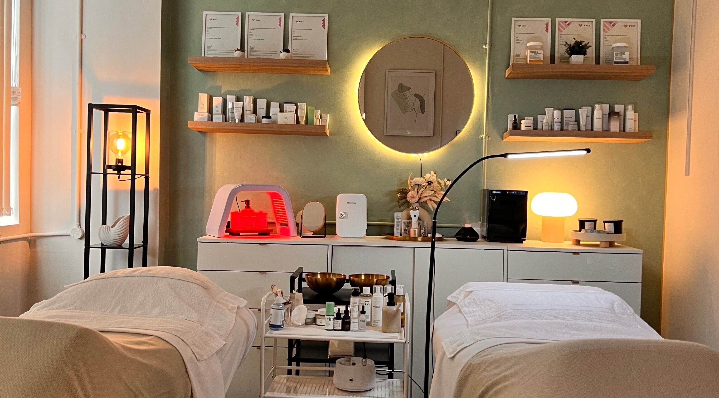 Elegant treatment room at Misskin & Laser Studio, Birmingham, England, GB, featuring warm lighting and skincare products.