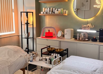Cozy treatment room at Misskin & Laser Studio, Birmingham, England, GB features ambient lighting and skincare products.