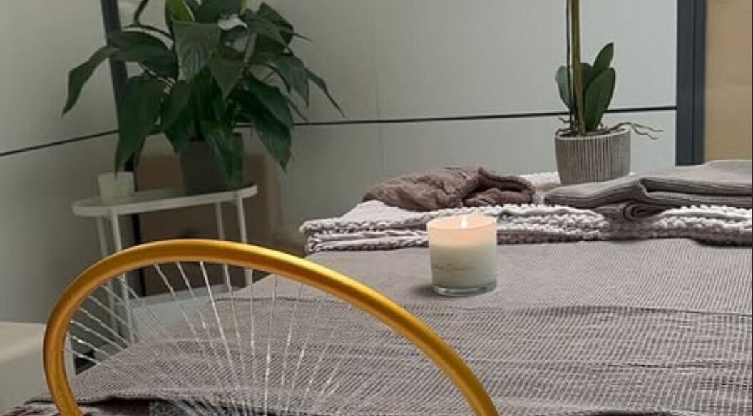 Relaxing massage table setup at Japonais Hair Spa in Luxembourg, Luxembourg, LU with candles and plants.