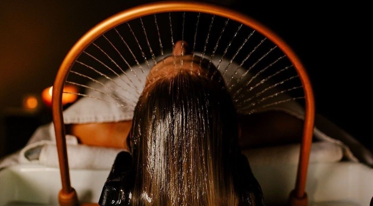 A relaxing hair wash session at Japonais Hair Spa in Luxembourg, Luxembourg, LU with calming ambiance lighting.