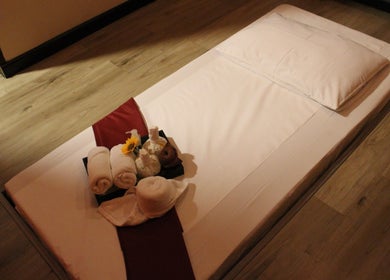 Relaxing spa setup at Feet Lounge Reflexology & Spa - Bay Avenue Mall, دبي, دبي, AE, featuring towels and flowers.